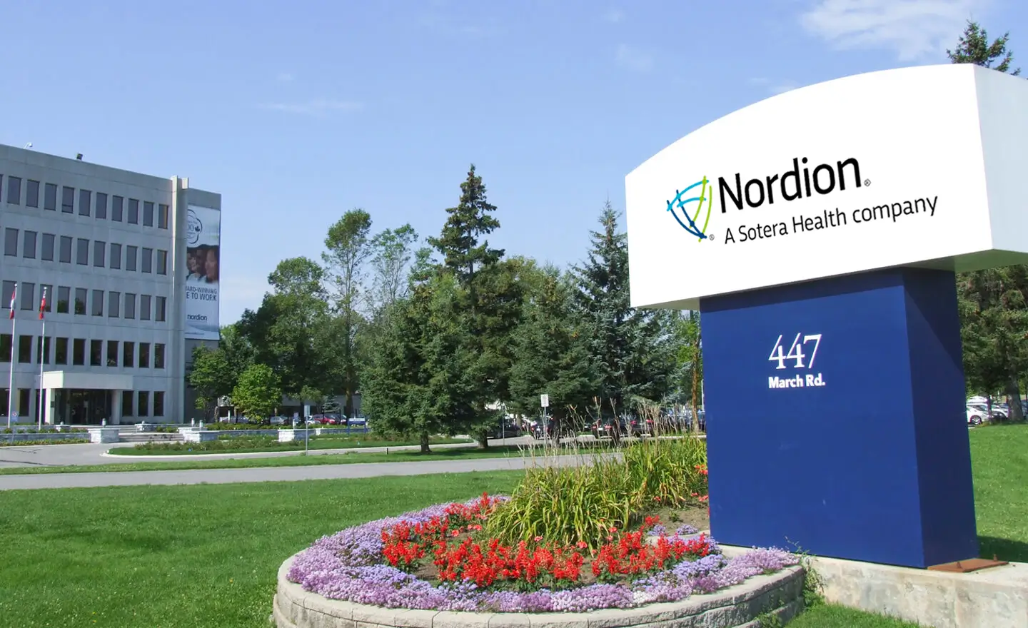 A sign displaying the Nordion logo in front of the Nordion building, with the address 447 March Rd.